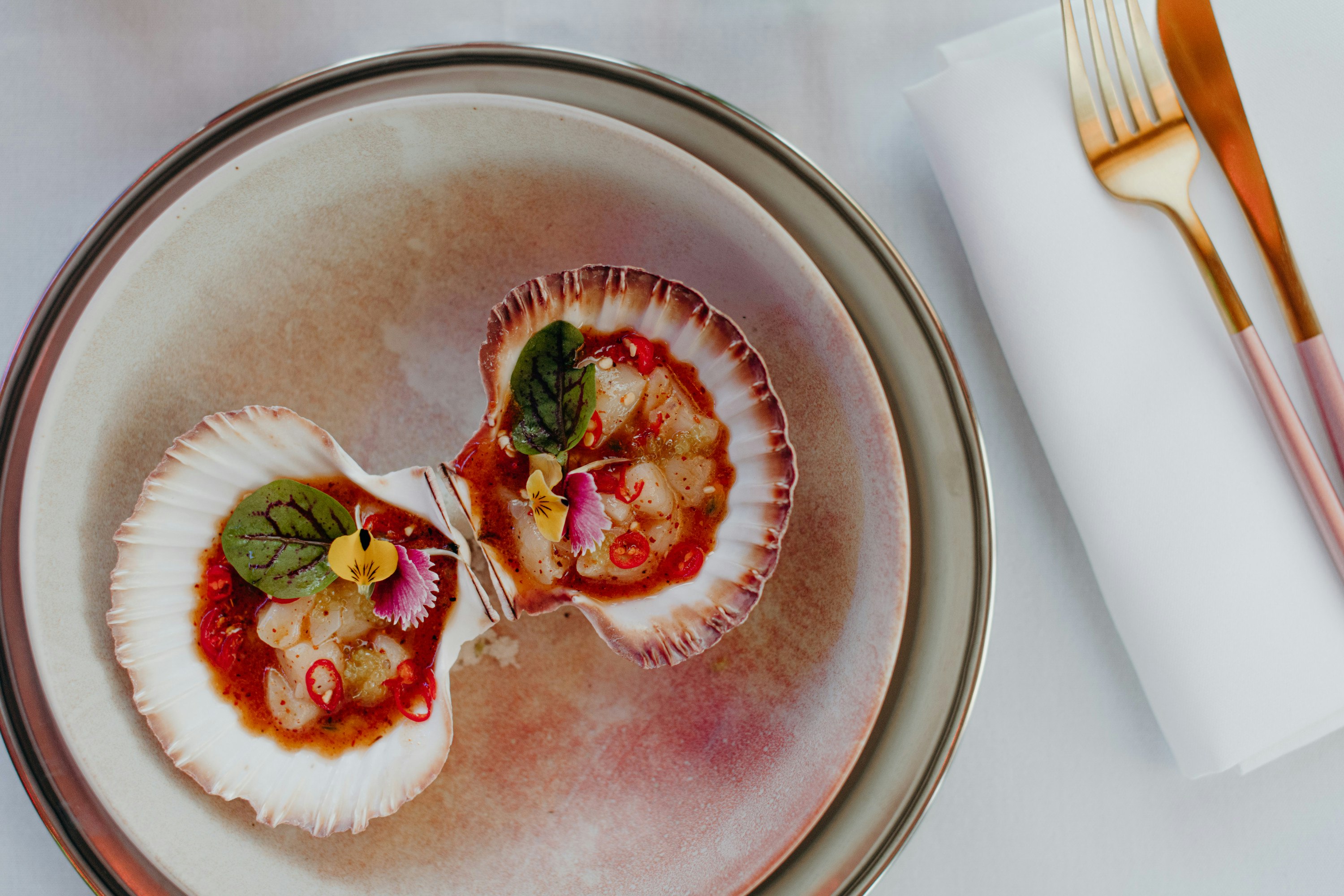a pair of scallops on a plate